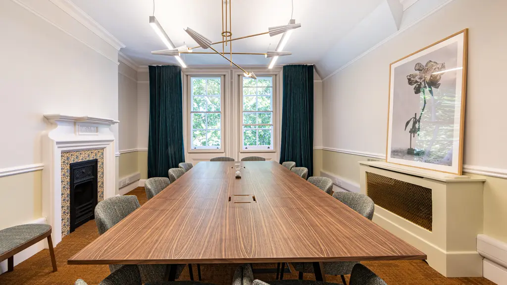 Boardroom at 128 Buckingham Palace Road with a long table, fireplace and tall windows